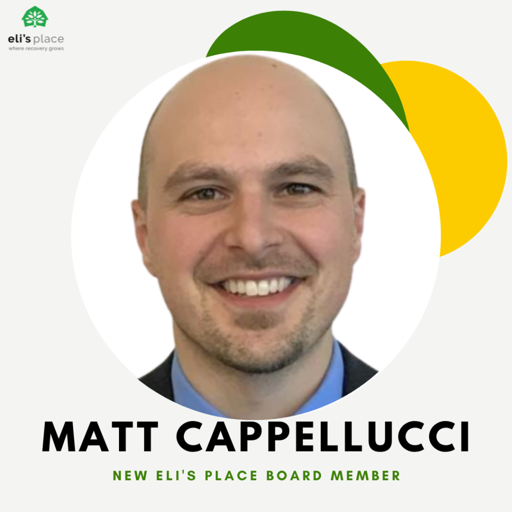 A headshot of a smiling man with a shaved head, set within a circular frame against a modern background. Below his photo, his name "MATT CAPPELLUCCI" is displayed above the subtitle "NEW ELI'S PLACE BOARD MEMBER." The circle is accented with decorative green and yellow abstract leaf shapes, and the "eli's place" logo is visible in the top left corner.