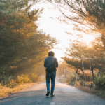person walking down road