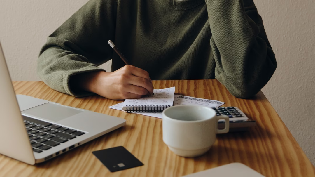 A person doing finances at a table Eli's Place The Intersection of Mental Illness and Financial Stress