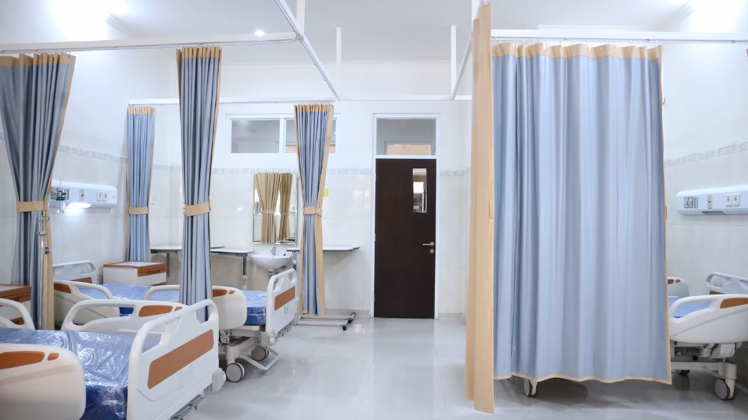 Mental Health Emergencies. An empty hospital ER with beds and curtains
